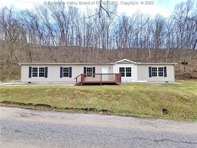 manufactured / mobile home featuring a front yard, crawl space, and a wooden deck