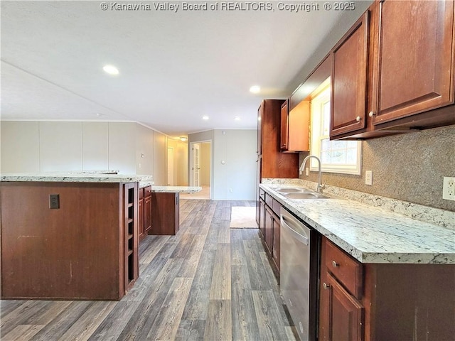 kitchen with wood finished floors, a sink, dishwasher, open shelves, and tasteful backsplash