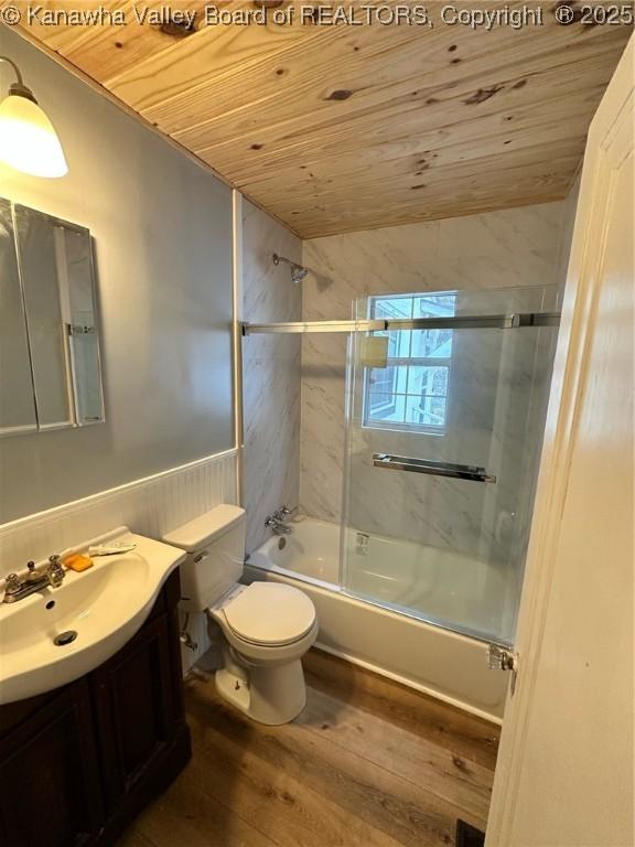 full bathroom with bath / shower combo with glass door, toilet, wood ceiling, vanity, and hardwood / wood-style flooring