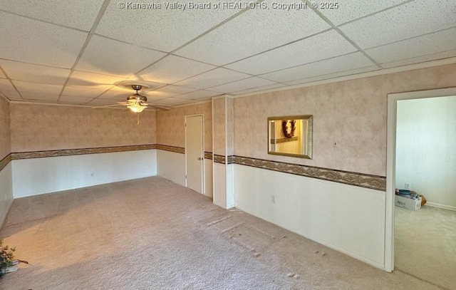 empty room with carpet floors and a drop ceiling