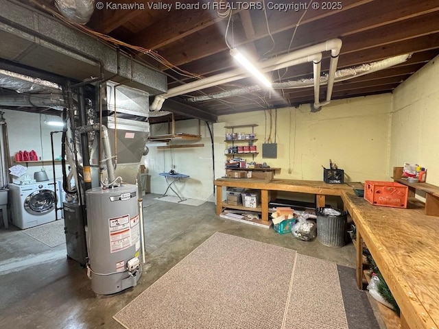 unfinished below grade area featuring washer / dryer and gas water heater