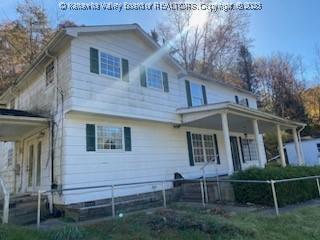 view of front of house featuring fence