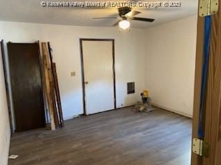 spare room featuring visible vents, a ceiling fan, and wood finished floors