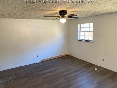 empty room with ceiling fan, a textured ceiling, and wood finished floors