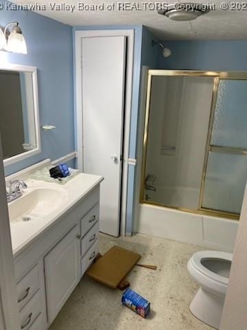 full bath featuring toilet, shower / bath combination with glass door, and vanity