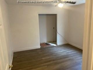 unfurnished room featuring baseboards and wood finished floors