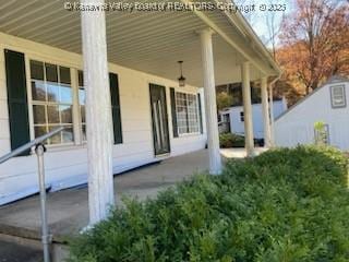 view of property exterior with a porch