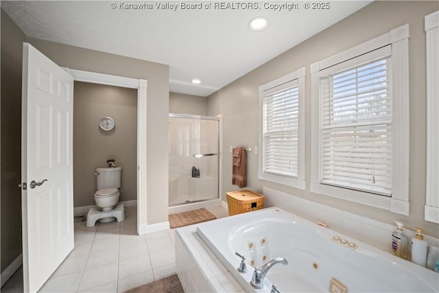 full bathroom with toilet, baseboards, tile patterned floors, a tub with jets, and a stall shower