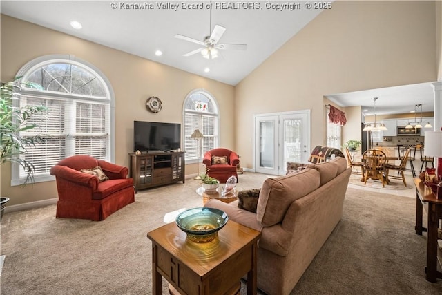 living area with baseboards, light colored carpet, ceiling fan, high vaulted ceiling, and recessed lighting