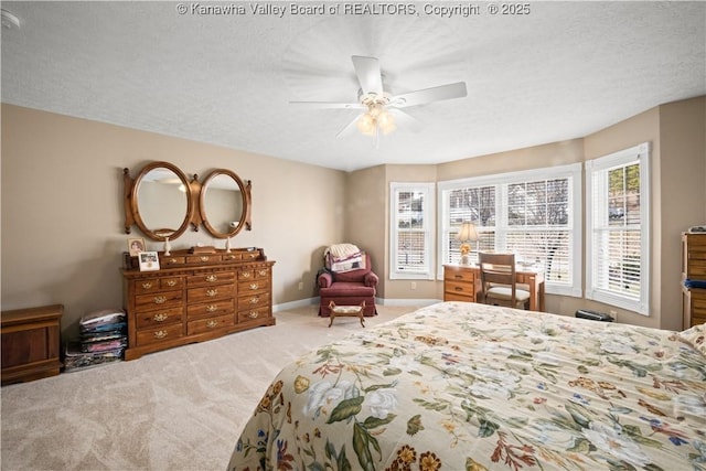 bedroom with carpet floors, a textured ceiling, baseboards, and a ceiling fan