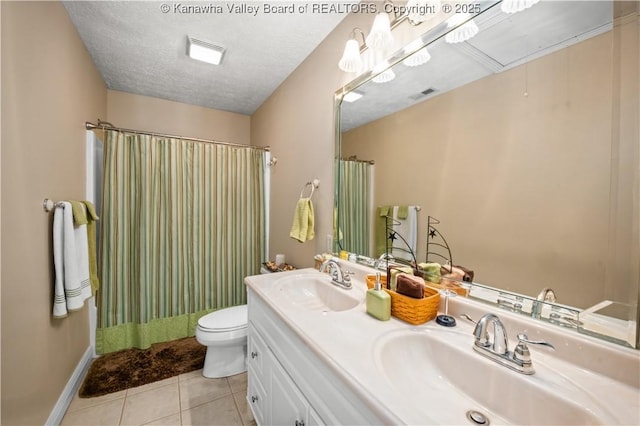 full bath featuring a textured ceiling, a sink, toilet, and tile patterned floors