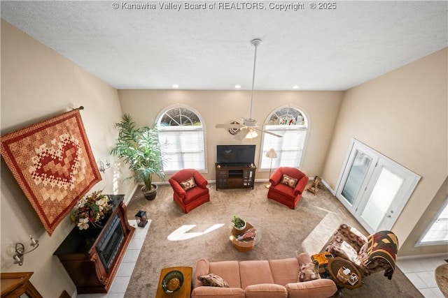 carpeted living room featuring recessed lighting, a fireplace, a textured ceiling, and baseboards