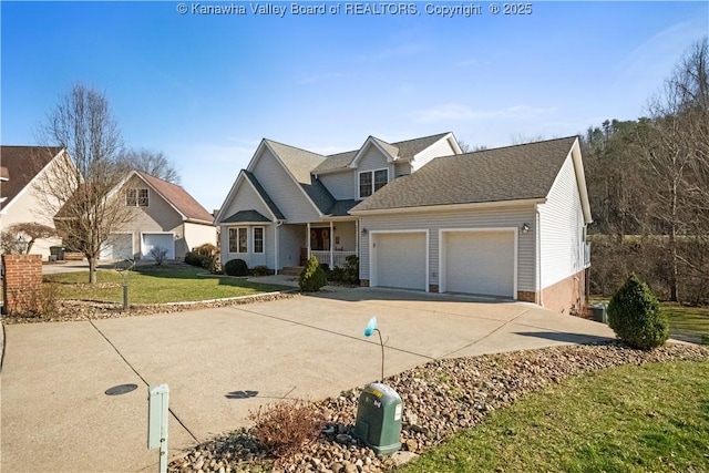 view of front of home featuring concrete driveway, an attached garage, and a front yard