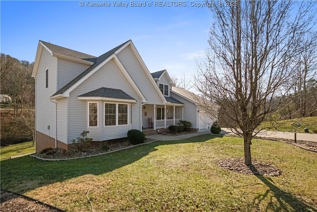 traditional-style home with a garage, covered porch, driveway, and a front lawn