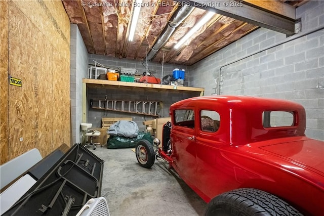 garage with concrete block wall