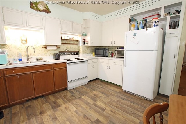 kitchen with white appliances, dark wood-style flooring, a sink, light countertops, and open shelves