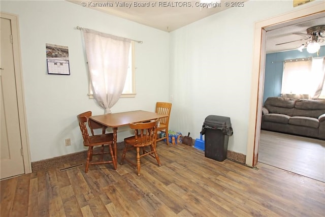 dining room featuring a ceiling fan and wood finished floors