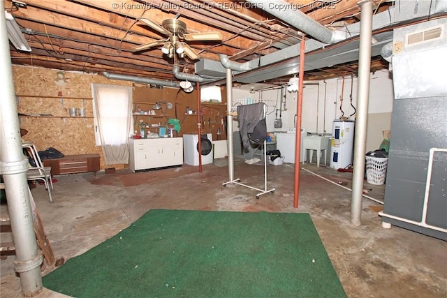 basement featuring heating unit, visible vents, electric water heater, a sink, and washer and dryer