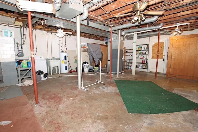 unfinished basement featuring electric water heater, a sink, and separate washer and dryer