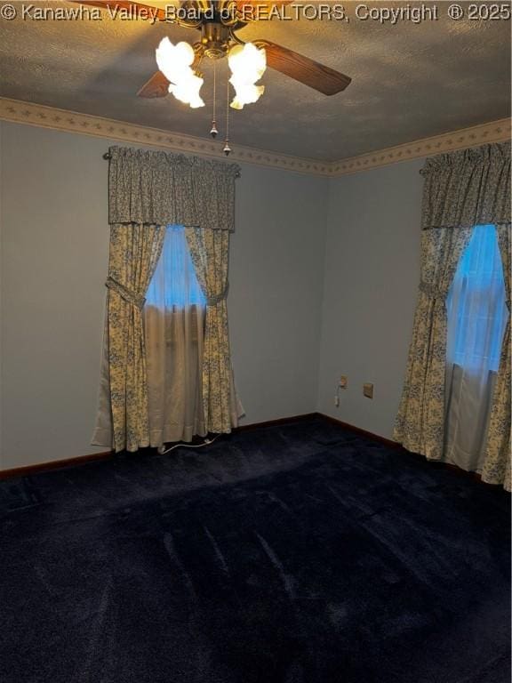 spare room featuring a textured ceiling, carpet, a ceiling fan, and baseboards