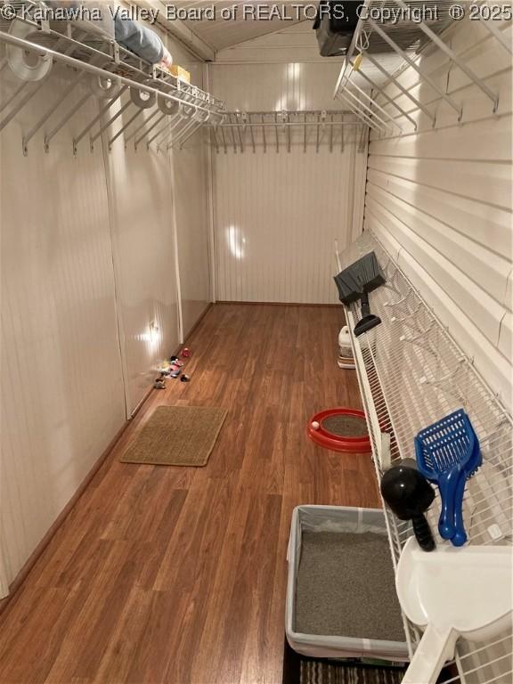 interior space featuring lofted ceiling and wood finished floors