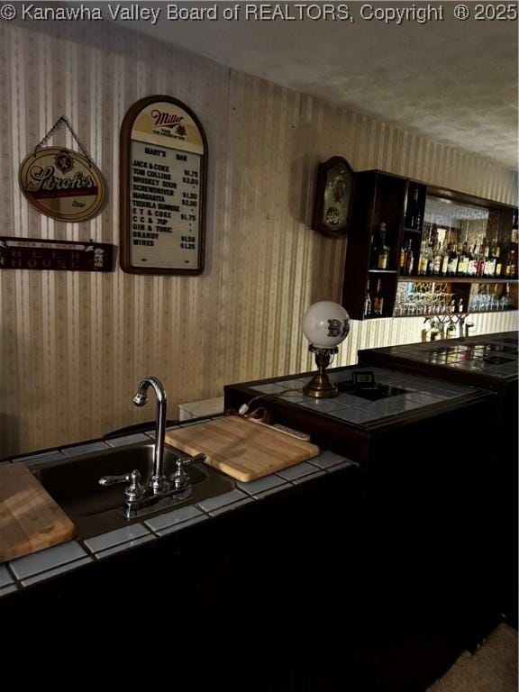 bar featuring wallpapered walls and indoor wet bar