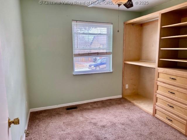 interior space with carpet, a closet, visible vents, and baseboards