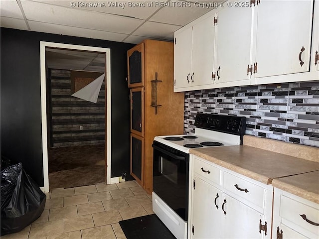 kitchen featuring white cabinets, decorative backsplash, electric range oven, light countertops, and a paneled ceiling