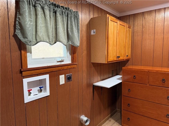 clothes washing area with wooden walls, washer hookup, ornamental molding, cabinet space, and electric dryer hookup