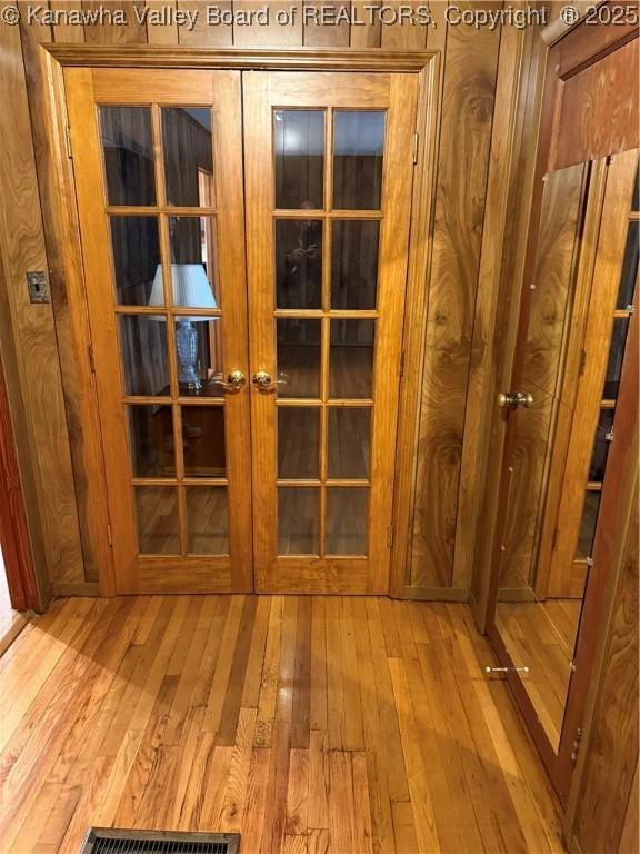 interior details featuring visible vents, wood finished floors, and french doors