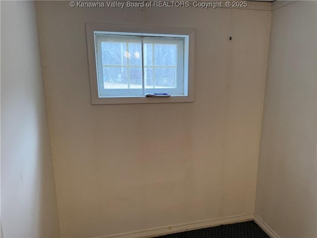 spare room with baseboards