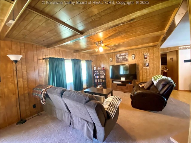 living room with wood ceiling, carpet flooring, wood walls, and beamed ceiling