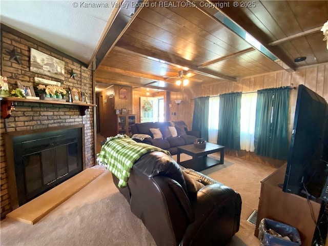 carpeted living area featuring beam ceiling, visible vents, a brick fireplace, wooden walls, and wooden ceiling