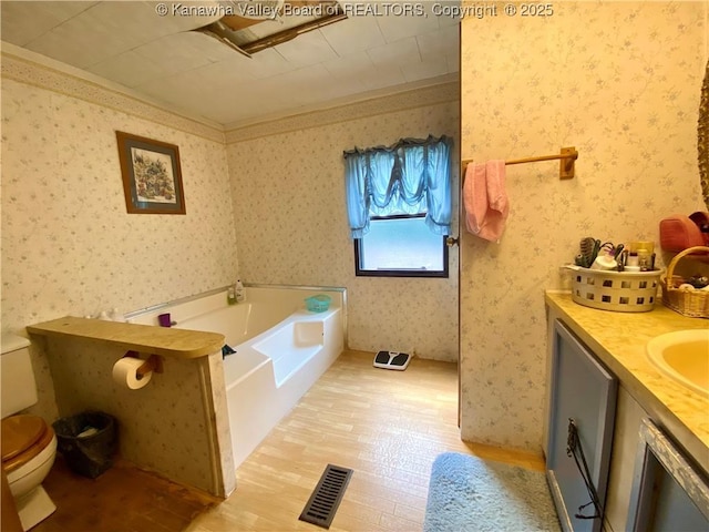 bathroom with wallpapered walls, visible vents, toilet, wood finished floors, and a bath