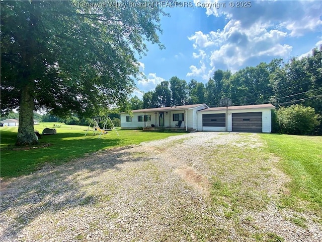 ranch-style home with an attached garage, driveway, a front yard, and a playground