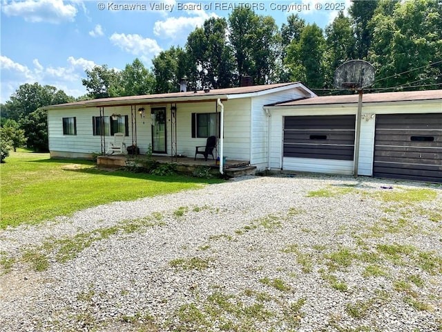 single story home with gravel driveway, a chimney, a porch, an attached garage, and a front lawn