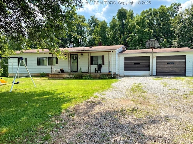 view of front of property with gravel driveway, a playground, covered porch, an attached garage, and a front yard