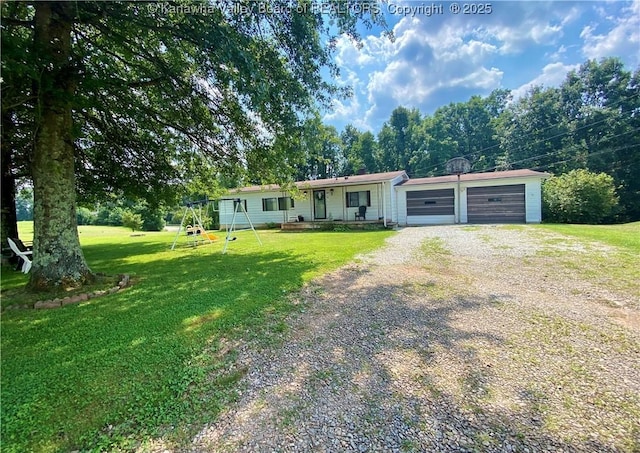 view of front of home featuring a garage, a front yard, a playground, and driveway