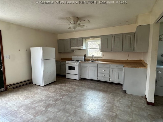 kitchen featuring gray cabinets, a baseboard heating unit, a sink, white appliances, and under cabinet range hood