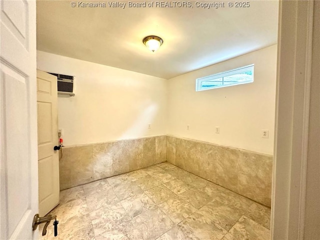 interior space with a wall unit AC and wainscoting