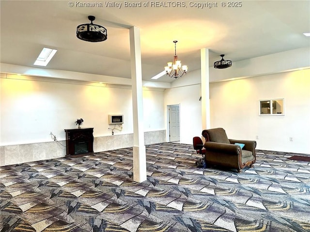 basement with an inviting chandelier and carpet flooring