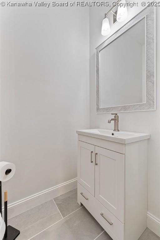 bathroom with tile patterned flooring, vanity, and baseboards