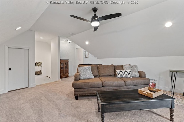 carpeted living area featuring recessed lighting, vaulted ceiling, and baseboards