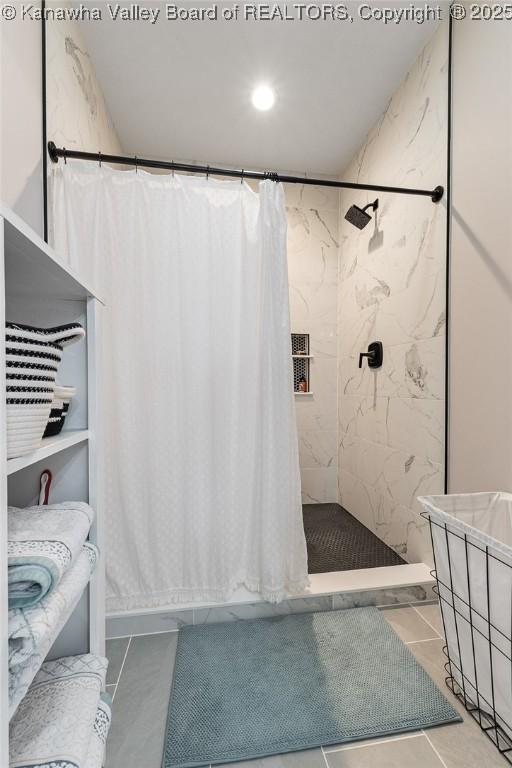 full bathroom with a shower with shower curtain and tile patterned floors