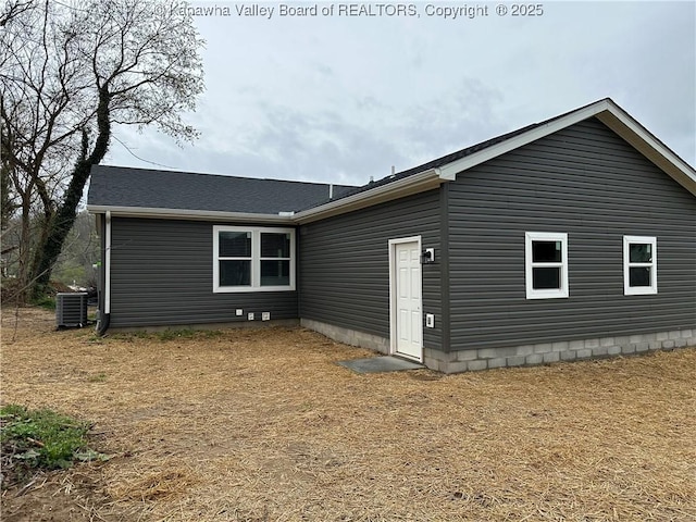 rear view of property with central AC