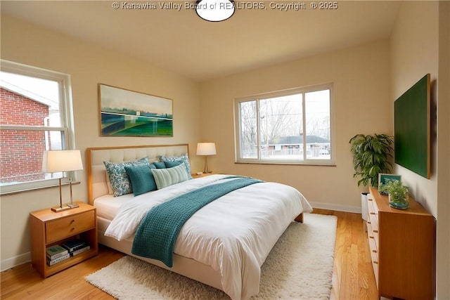 bedroom with light wood-style floors and baseboards