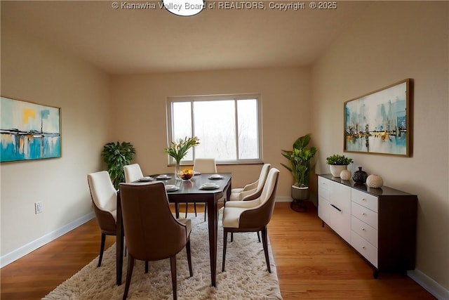 dining room featuring light wood-style flooring and baseboards