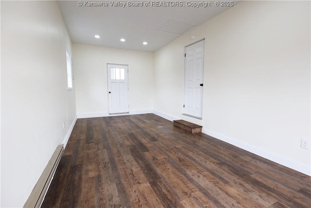 spare room with dark wood-type flooring, recessed lighting, baseboards, and baseboard heating