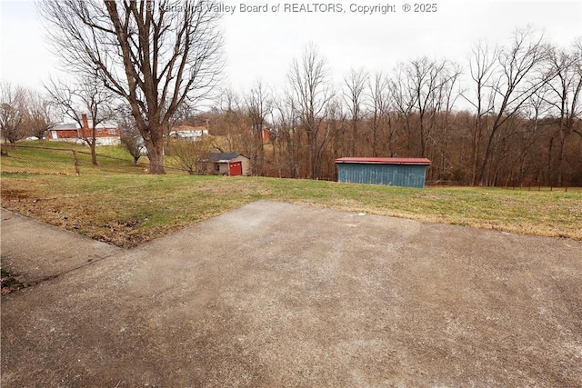 view of yard featuring an outdoor structure and fence