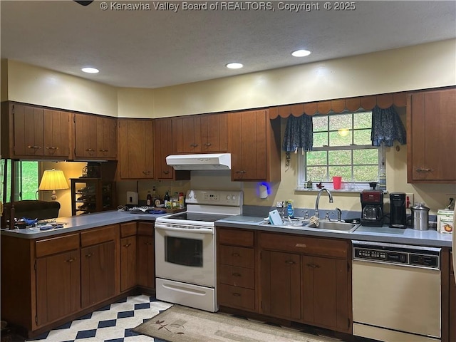 4915 Chesterfield Ave, Charleston, WV 25304 - kitchen with recessed lighting, under cabinet range hood, a sink, white appliances, and a peninsula